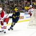 Michigan defenseman Jon Merrill tries to skate around Miami left wingman Curtis McKenzie on Saturday, March 23. Daniel Brenner I AnnArbor.com